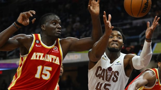 Oct 12, 2022; Cleveland, Ohio, USA; Atlanta Hawks center Clint Capela (15) and Cleveland Cavaliers guard Donovan Mitchell (45) go for a rebound during the second half at Rocket Mortgage FieldHouse. Mandatory Credit: Ken Blaze-USA TODAY Sports
